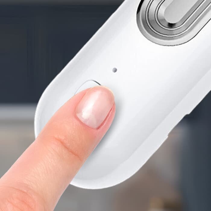Finger pressing the power button on the Ozoori